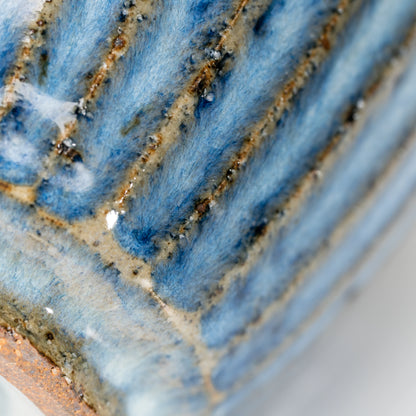 Close-up of the vertical ribs and flowing blue-gray glaze.