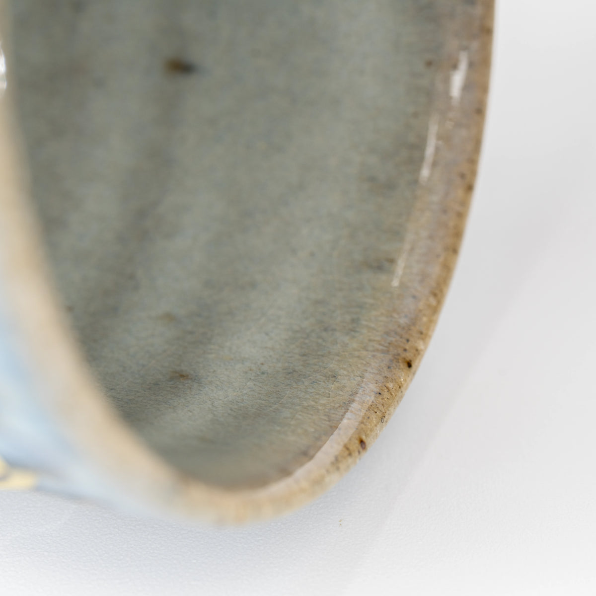 Glazed interior and rounded brown rim of the yunomi.