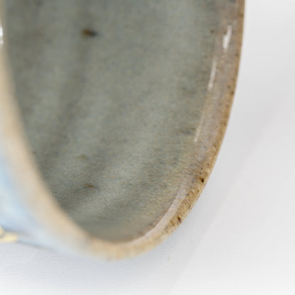 Glazed interior and rounded brown rim of the yunomi.