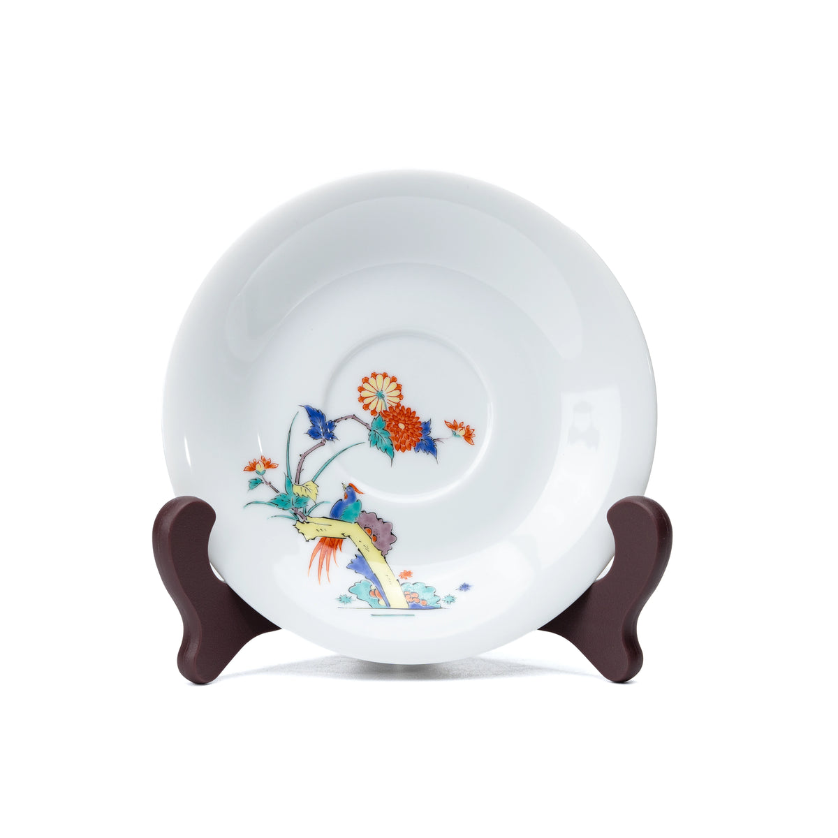 White porcelain saucer with chrysanthemums and birds, viewed from above.