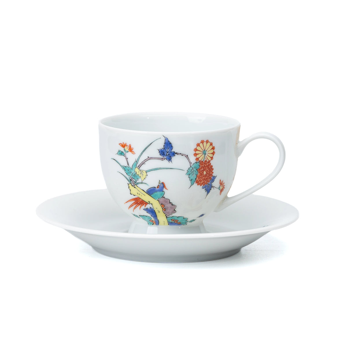 White porcelain cup and saucer with chrysanthemums and birds on white.