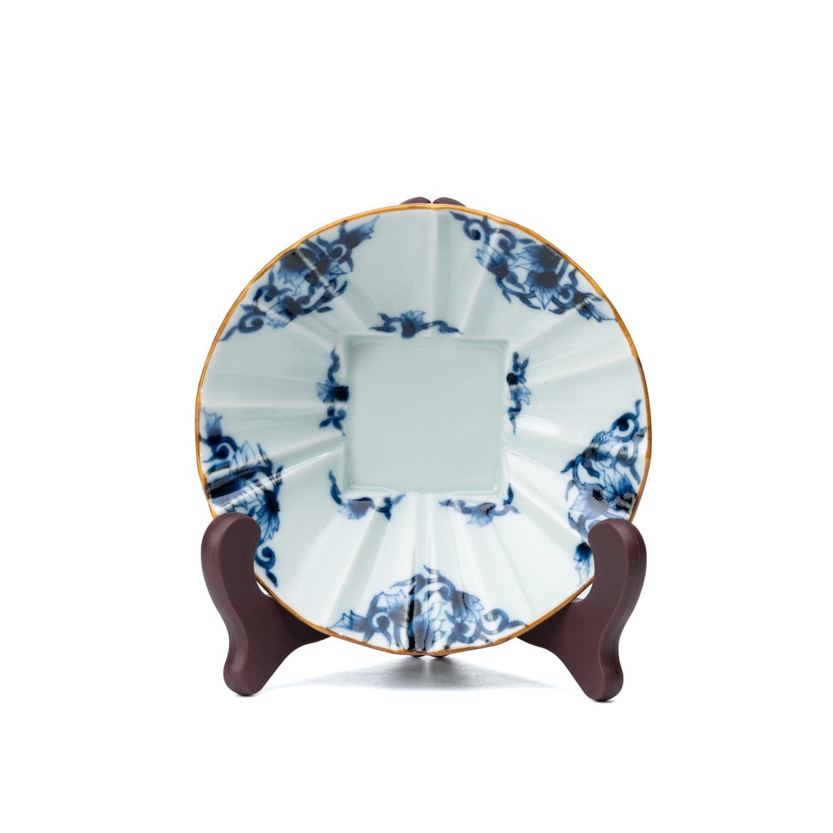 Blue and white bowl displayed upright on a small stand.