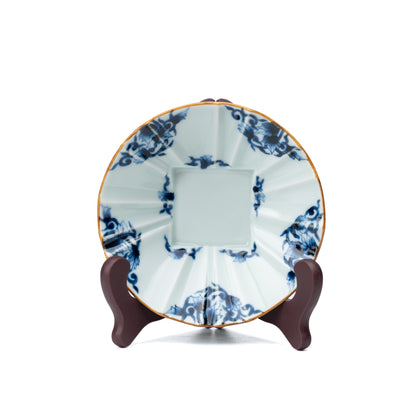 Blue and white bowl displayed upright on a small stand.
