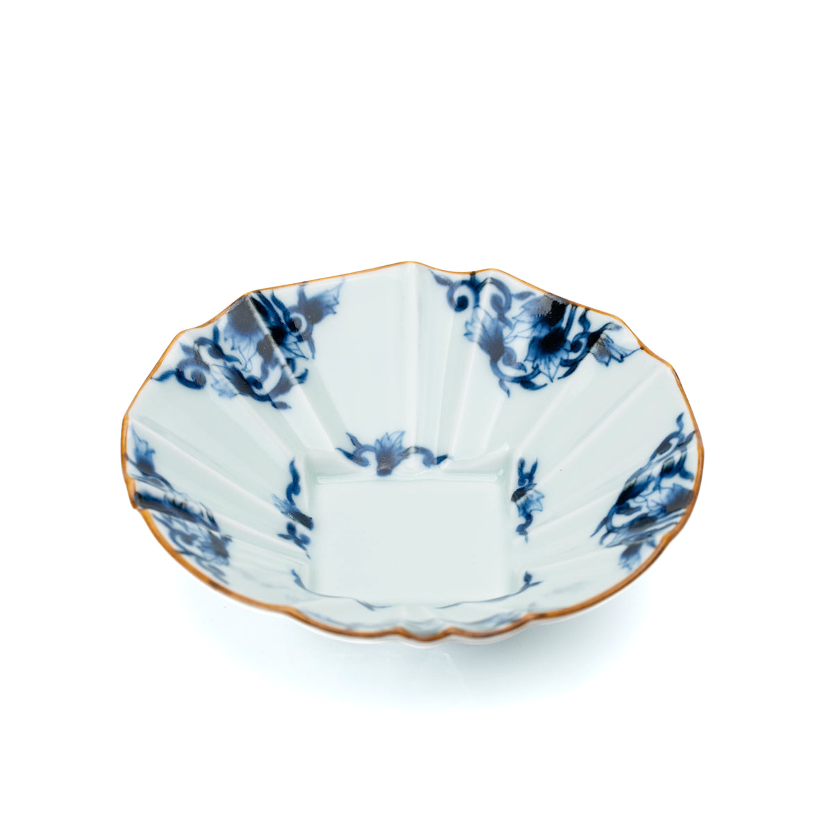 Blue and white porcelain bowl with a scalloped gold-edged rim and arabesque decoration on white.
