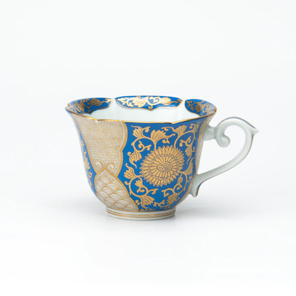 Side view of the blue and gold cup with a white handle.