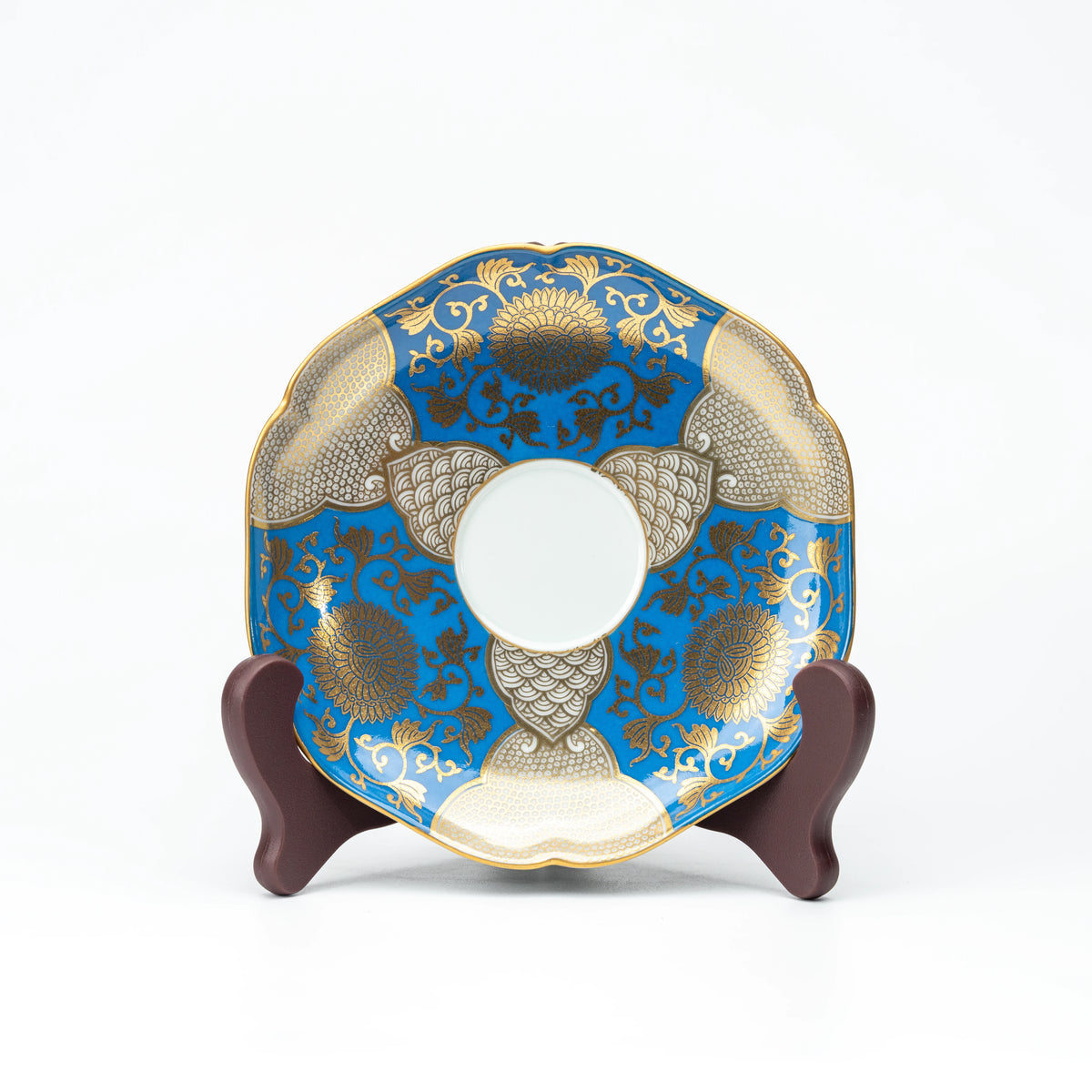 Blue and gold saucer displayed upright on a small stand.