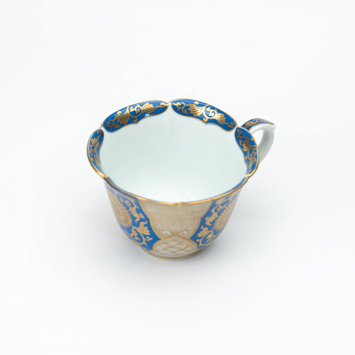 Top view into the blue and gold cup with its white interior.