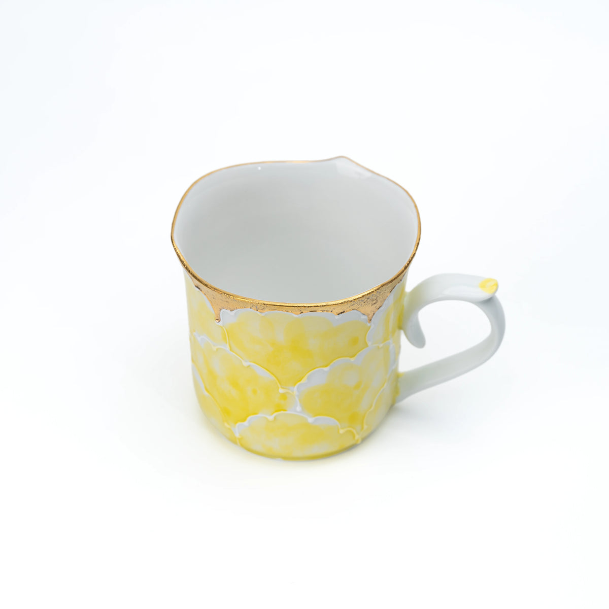 Top view into the yellow peony mug and its white interior.