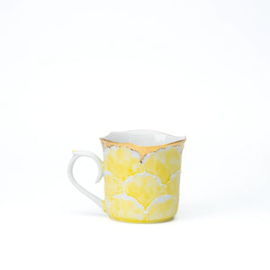 Yellow peony porcelain mug with a scalloped gold rim on white.