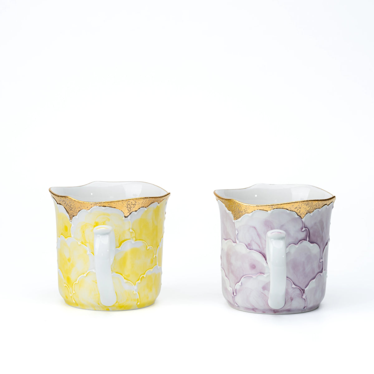 Handle sides of the yellow and purple mugs shown together for comparison.