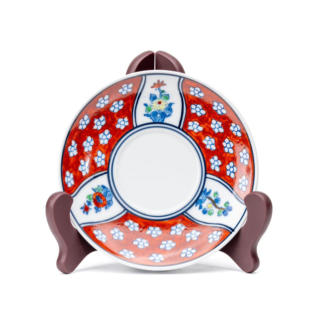 Red floral saucer displayed upright on a small stand.