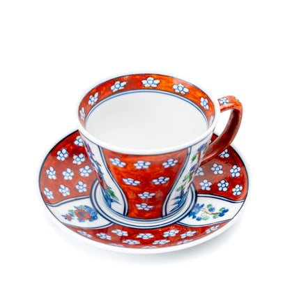 Red cup and saucer viewed from above, showing the white cup interior.