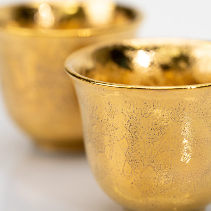 Close-up of the textured gold glaze on the cups.