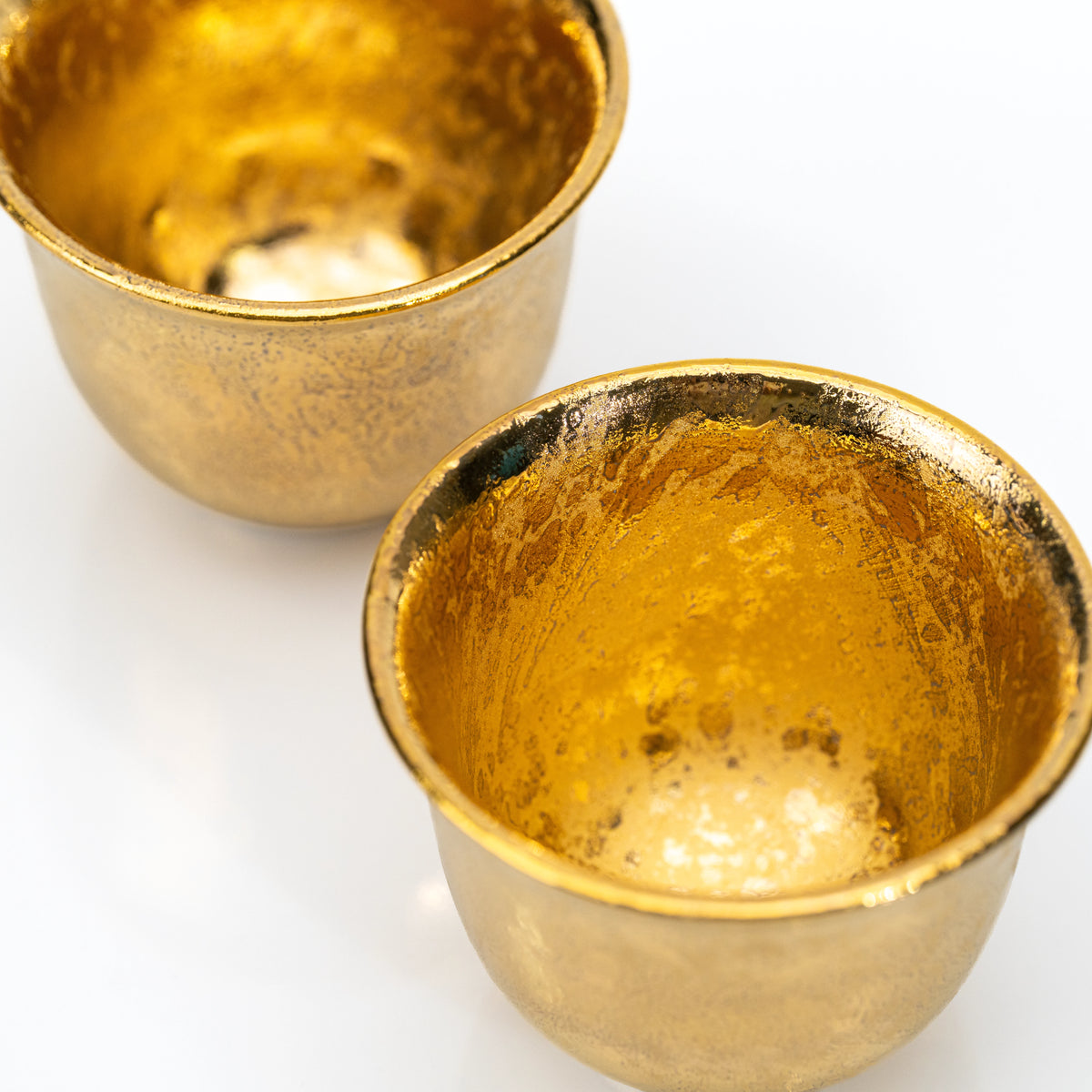 Gold interiors of the two small cups.
