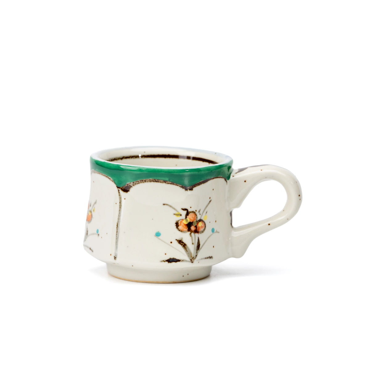Side view of the small green floral cup and curved handle.
