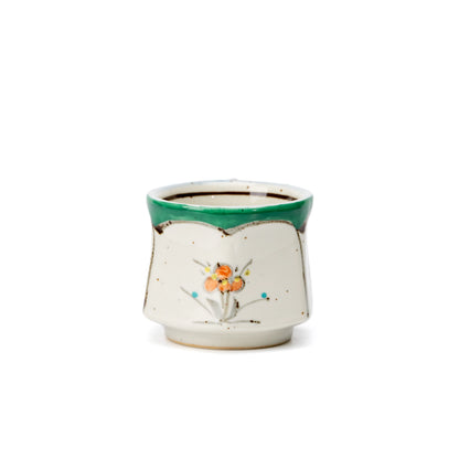 Opposite side of the green-rimmed floral cup.