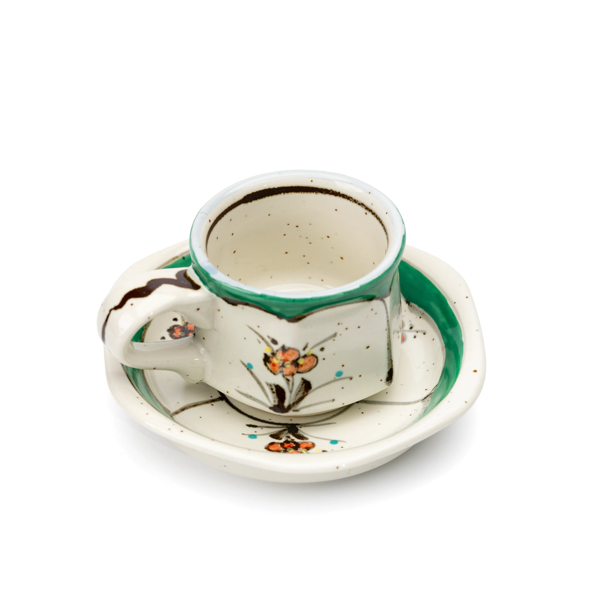 Overhead view into the green floral cup on its saucer.