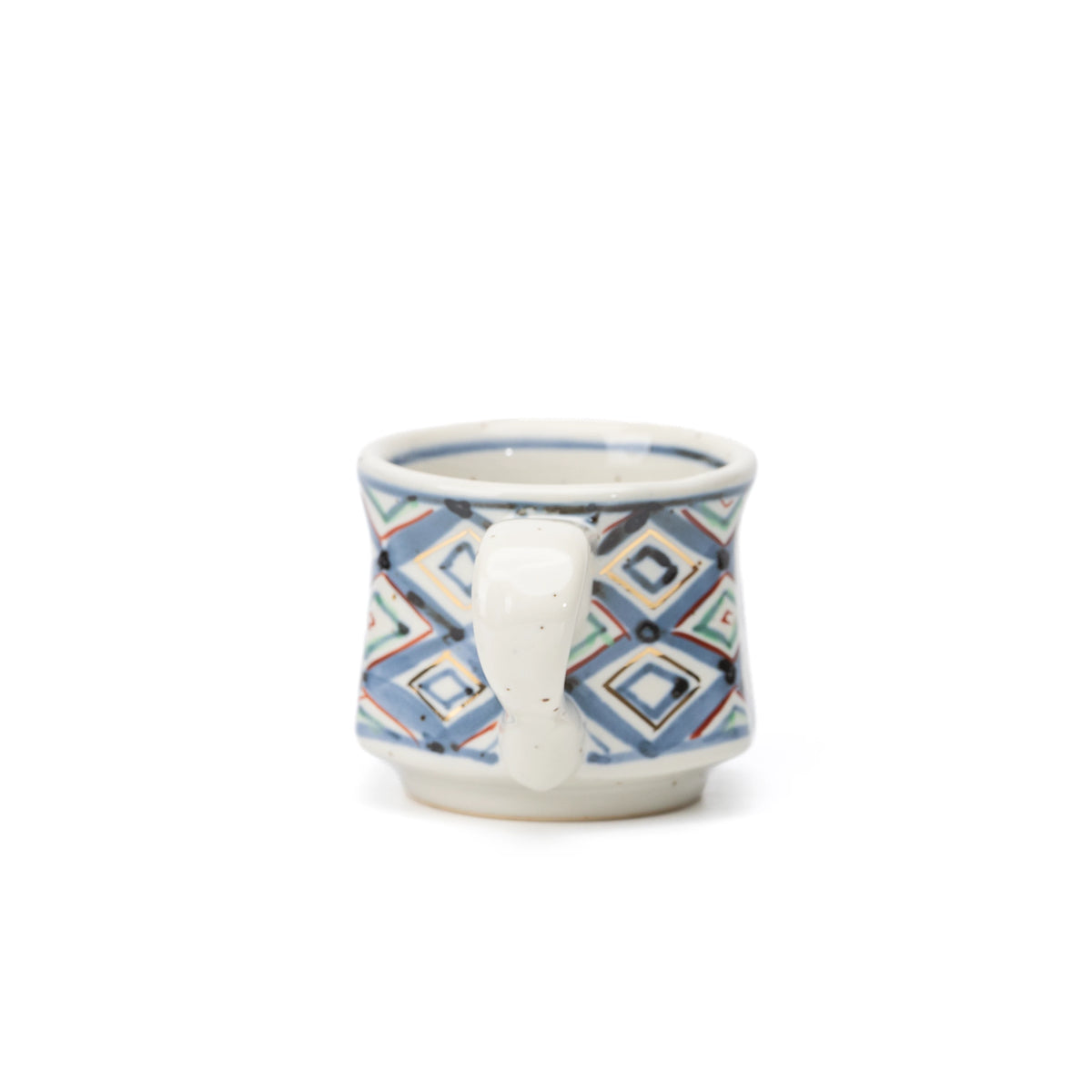Side view of the patterned demitasse cup and pale handle.