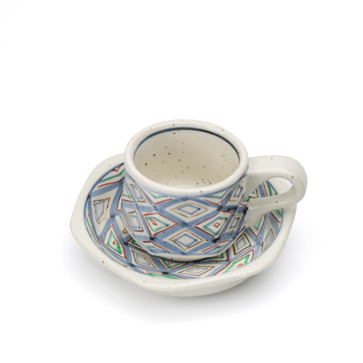 Angled view of the cup's pale interior and matching saucer.