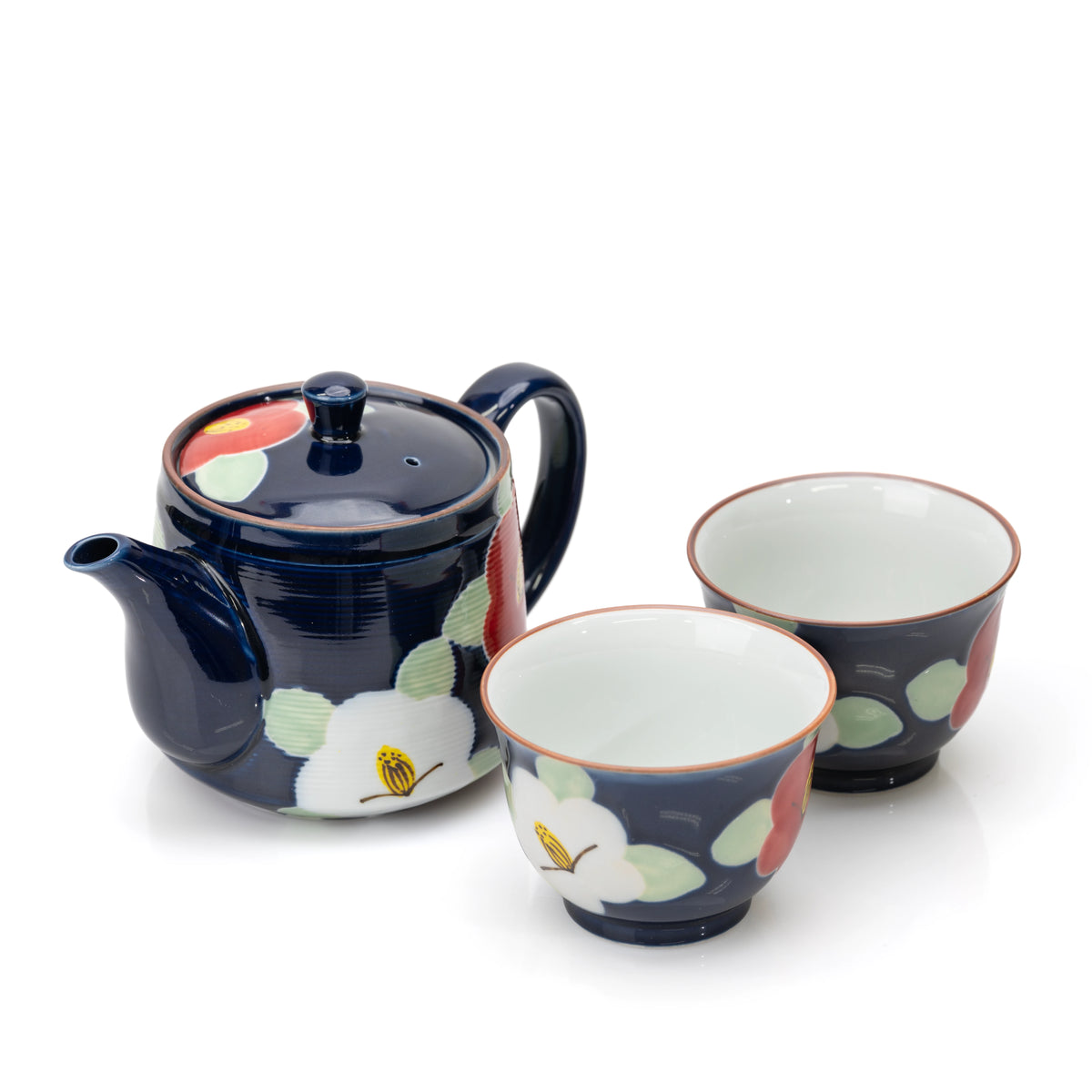 Angled view of the blue camellia teapot and two cups.