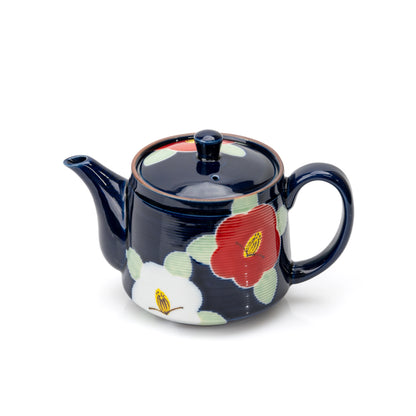 Deep blue teapot with red and white camellias, viewed from the side.