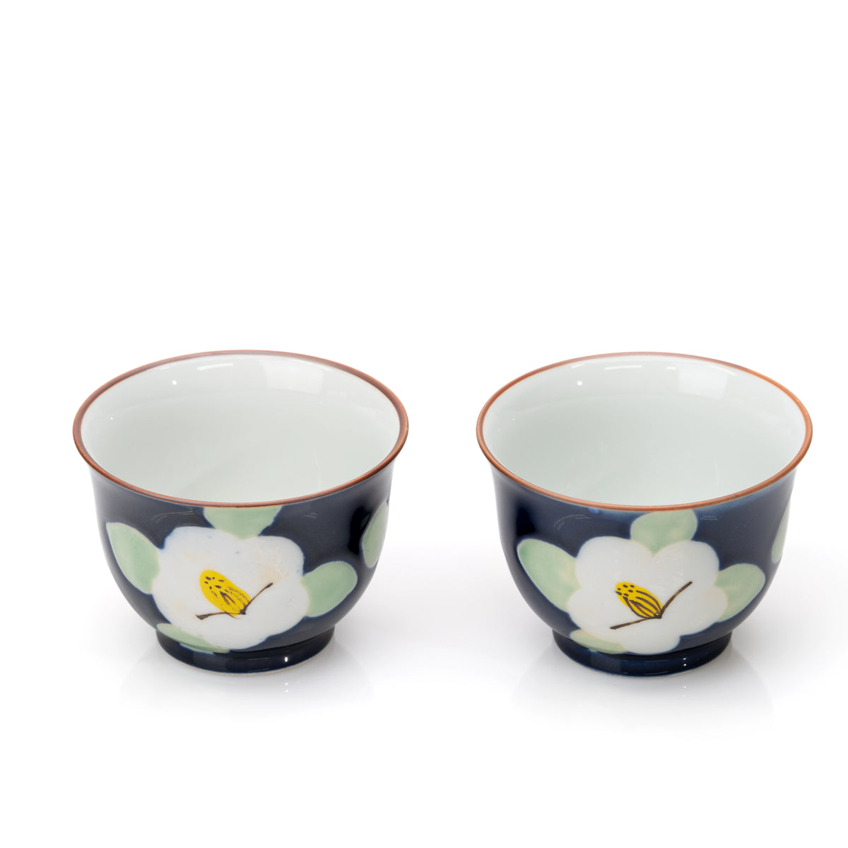 Two blue camellia cups showing their white interiors.