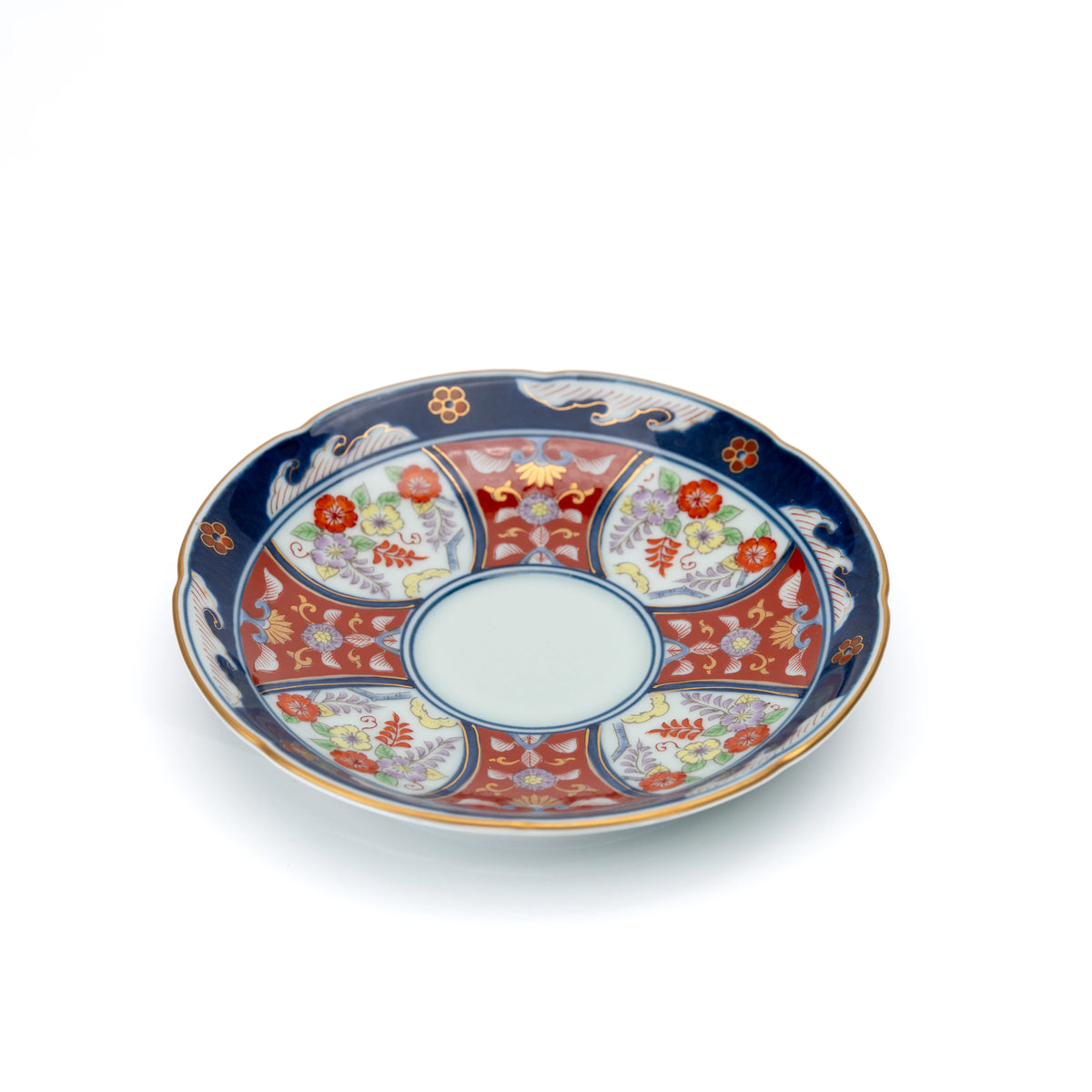 Angled view of the blue-rimmed floral saucer.