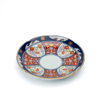 Angled view of the blue-rimmed floral saucer.