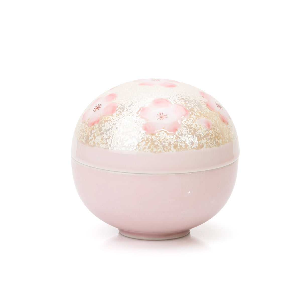 Round pink porcelain lidded bowl with cherry blossoms and pale textured decoration on white.