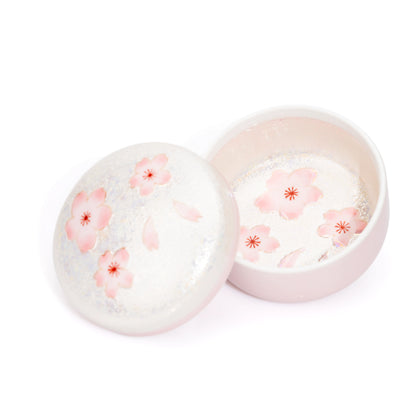 Open pink lidded box with floral interior and lid resting beside it.