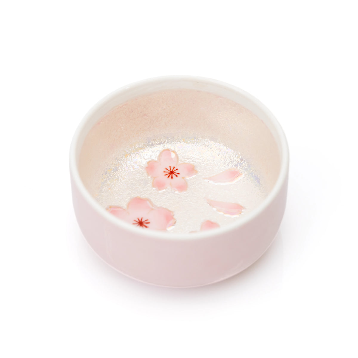 Open pink porcelain box showing cherry blossoms inside.