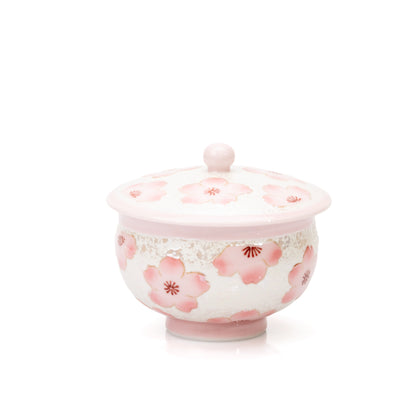 Pink cherry blossom porcelain teacup with matching knobbed lid on white.