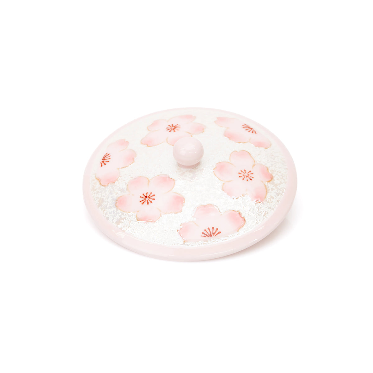 Top view of the pink cherry blossom lid and its rounded knob.