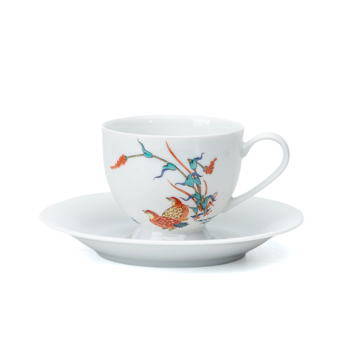 White porcelain cup and saucer with quail and red berries on white.