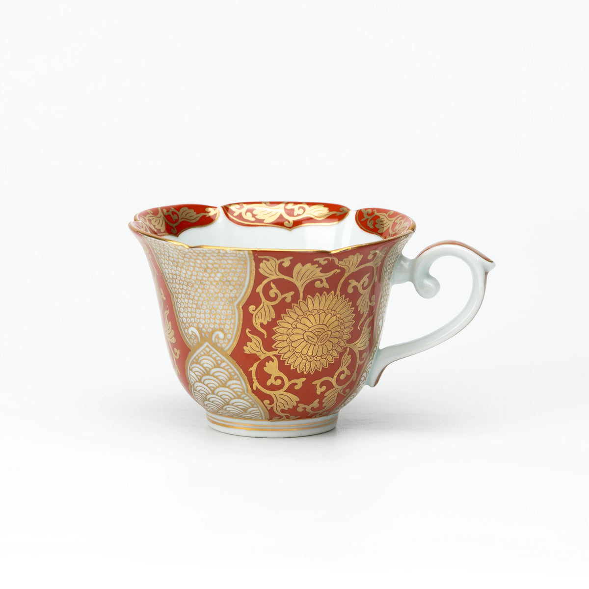 Side view of the red and gold cup with a white curved handle.