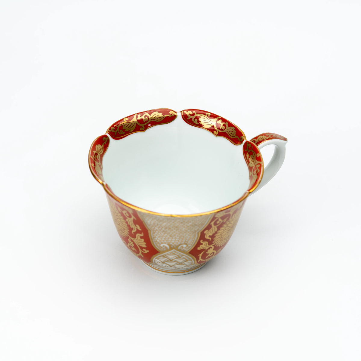 Top view into the red and gold cup with its white interior.
