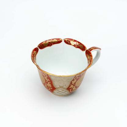 Top view into the red and gold cup with its white interior.