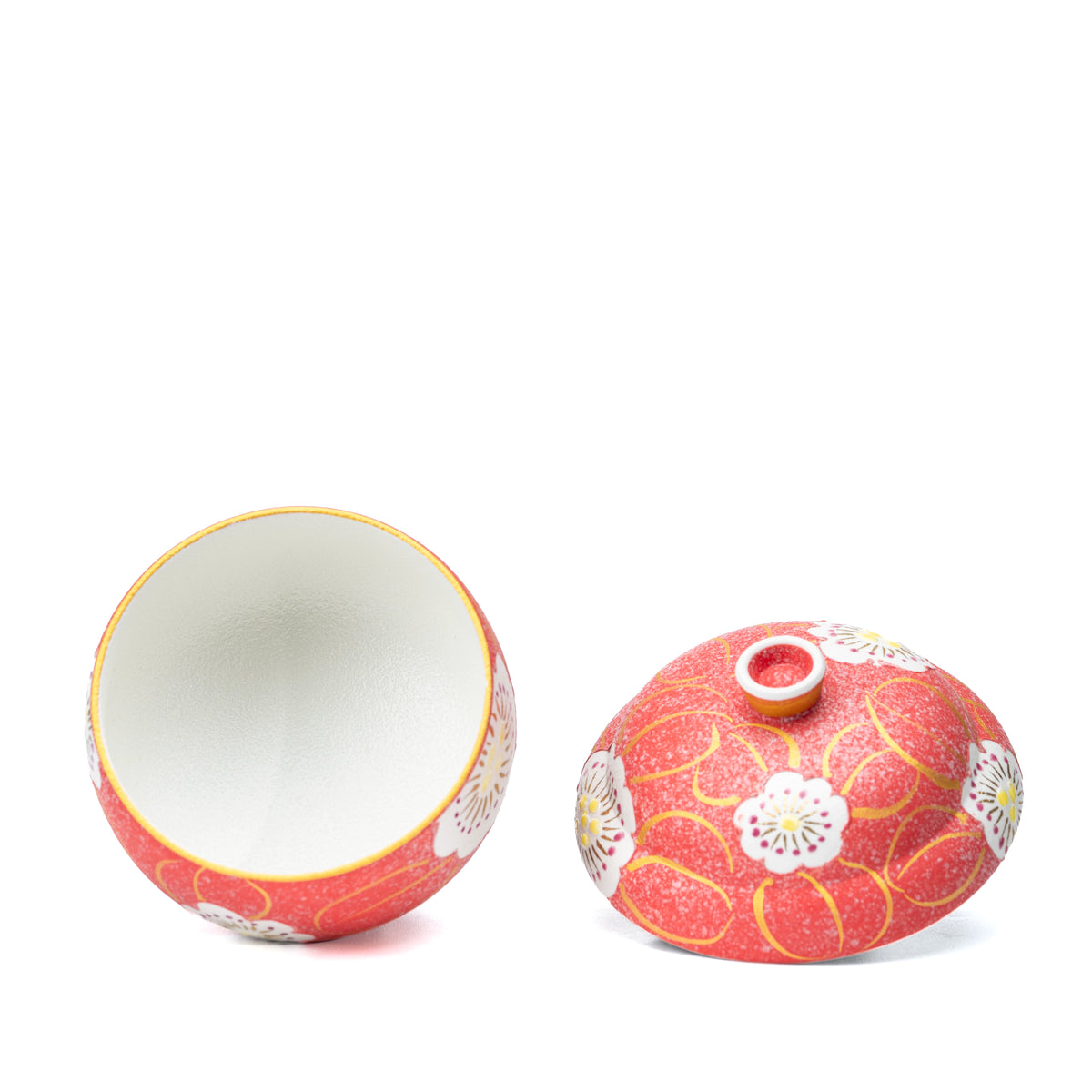 Overhead view into the red bowl with its lid beside it.