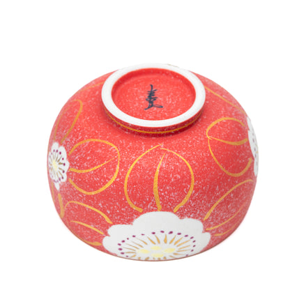 Underside of the red floral bowl with a blue maker's mark.