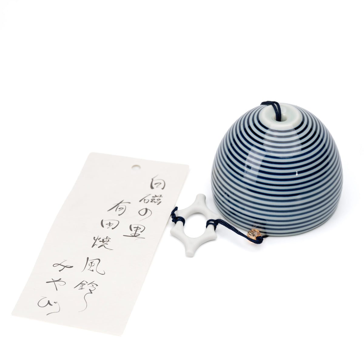 Blue and white striped porcelain wind chime with a paper strip on white.
