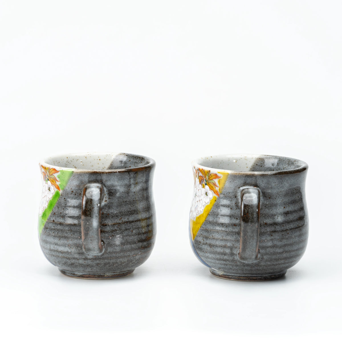 Back view of the Kutani bird mug pair showing their handles.