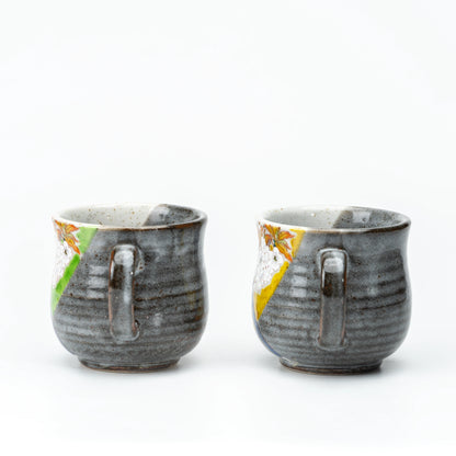 Back view of the Kutani bird mug pair showing their handles.