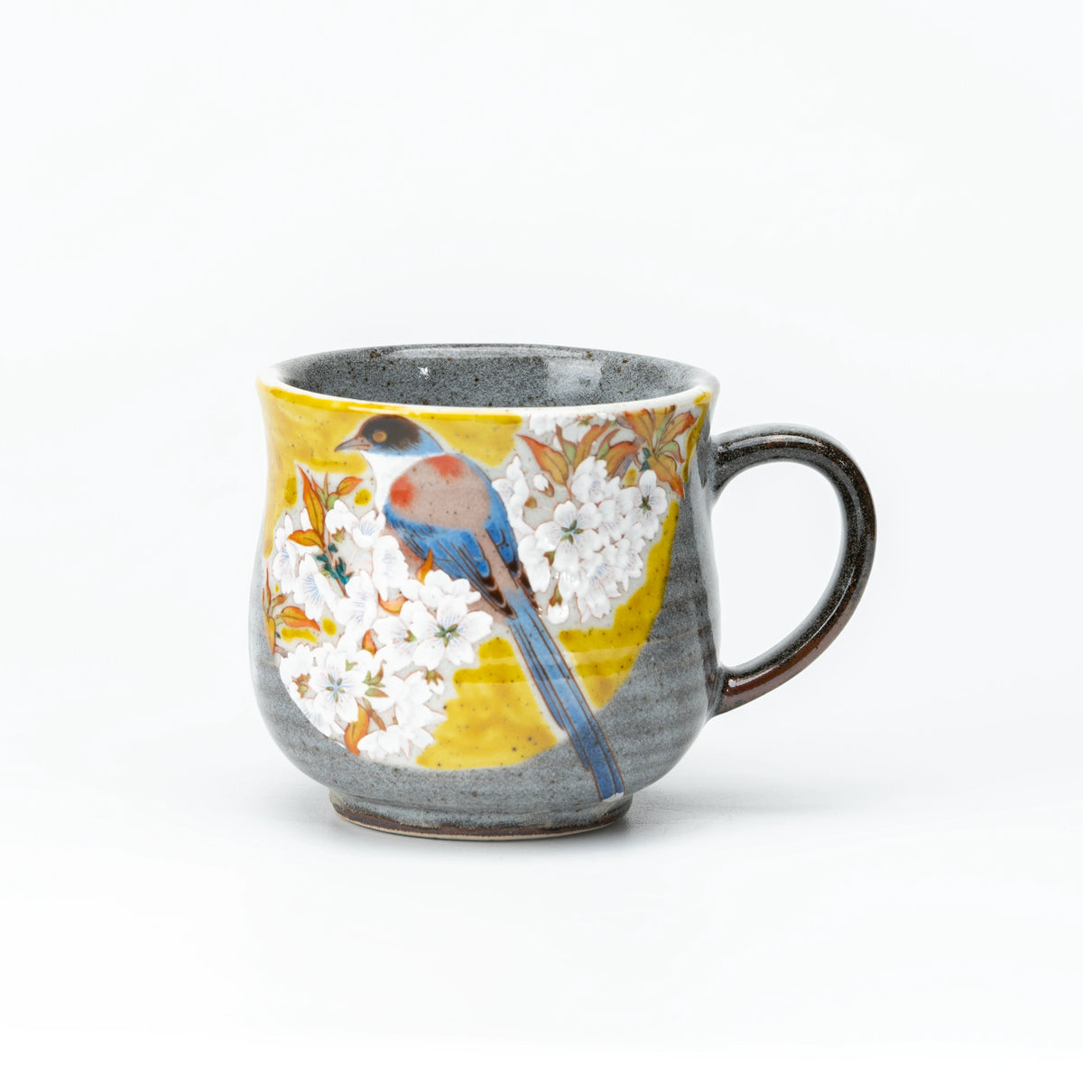 Front view of the yellow Kutani bird and cherry blossom mug.