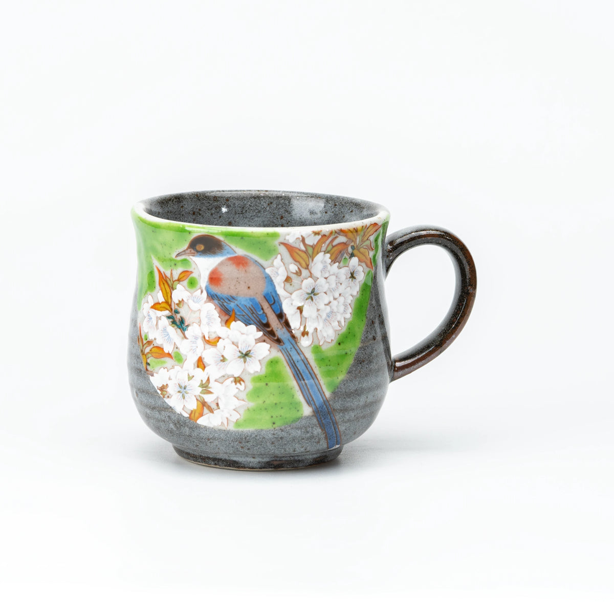 Front view of the green Kutani bird and cherry blossom mug.