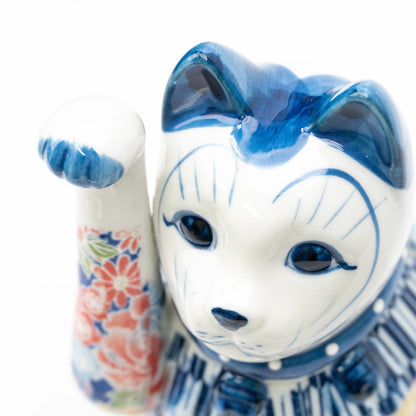 Close-up of the cat's blue ears, white face and raised paw.