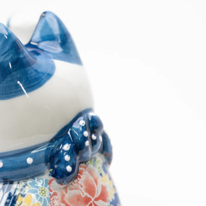 Close-up of the blue collar and side of the cat's head.