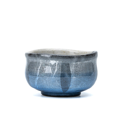 Rounded Kutani matcha bowl with pale blue and silver-foil panels on white.