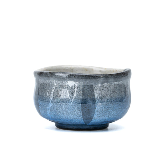 Rounded Kutani matcha bowl with pale blue and silver-foil panels on white.