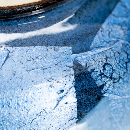 Blue and dark gray glazed panels around the bowl.