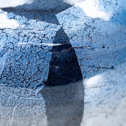 Fine silver-foil lines beneath blue glaze.